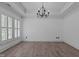 Dining room with tray ceilings, neutral walls, hardwood style floors, chandelier, and lots of light at 3323 Cheswick Dr, Raleigh, NC 27609