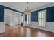 Elegant dining room with hardwood floors, wainscoting, and large windows with plantation shutters at 3323 Cheswick Dr, Raleigh, NC 27609