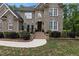 Imposing brick home with a multi-level entrance and meticulously maintained front garden at 3323 Cheswick Dr, Raleigh, NC 27609