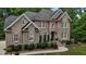 Elegant brick facade accented by symmetrical windows and professional landscaping for exceptional curb appeal at 3323 Cheswick Dr, Raleigh, NC 27609