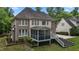 View of the home's rear featuring a spacious deck, screened-in porch, and brick accents at 3323 Cheswick Dr, Raleigh, NC 27609