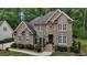 Charming brick home featuring classic architecture, lush greenery and inviting curb appeal at 3323 Cheswick Dr, Raleigh, NC 27609