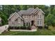 Stunning brick home with detailed trim, complemented by mature landscaping and a manicured lawn at 3323 Cheswick Dr, Raleigh, NC 27609