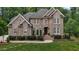 Beautiful brick home with well-manicured landscaping and a welcoming front entrance at 3323 Cheswick Dr, Raleigh, NC 27609