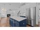 Stylish kitchen featuring stainless steel appliances, a center island, and views into the living room at 3323 Cheswick Dr, Raleigh, NC 27609