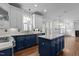 Modern kitchen features a center island, stainless steel appliances, custom cabinetry, and hardwood flooring at 3323 Cheswick Dr, Raleigh, NC 27609
