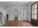 Open-concept living area with hardwood floors, fireplace, and a view of the entryway and study at 3323 Cheswick Dr, Raleigh, NC 27609