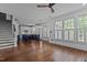 Open floor plan with hardwood flooring, a modern kitchen, and large windows with plantation shutters at 3323 Cheswick Dr, Raleigh, NC 27609