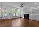 Inviting living room with fireplace, custom built-ins, large windows with plantation shutters, and hardwood floors at 3323 Cheswick Dr, Raleigh, NC 27609