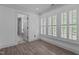 Bright living room with hardwood style floors, neutral walls, and lots of windows at 3323 Cheswick Dr, Raleigh, NC 27609