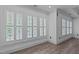 Sun-filled living room featuring hardwood style floors, neutral walls, and lots of windows at 3323 Cheswick Dr, Raleigh, NC 27609