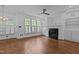 Cozy living room with a fireplace, built-in shelving, plantation shutters, and hardwood floors at 3323 Cheswick Dr, Raleigh, NC 27609