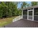 View of the spacious deck with white railings and the screened-in porch at 3323 Cheswick Dr, Raleigh, NC 27609