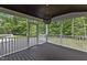 Screened in back porch with a wooden ceiling and a view of the wooded backyard at 3323 Cheswick Dr, Raleigh, NC 27609