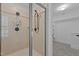 Modern tiled shower with glass door and a view into the walk-in closet at 3323 Cheswick Dr, Raleigh, NC 27609