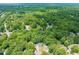 Aerial view of a home nestled among lush green trees in a residential neighborhood at 3401 Sitzman Ct, Raleigh, NC 27616