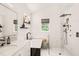Bright bathroom featuring a soaking tub and glass-enclosed shower with modern fixtures, and marble tiling at 3401 Sitzman Ct, Raleigh, NC 27616