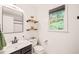 Bathroom features an open concept with floating shelving above the toilet and a large window for natural light at 3401 Sitzman Ct, Raleigh, NC 27616