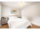 Bright bedroom with ceiling fan features hardwood flooring, two windows and a queen sized bed at 3401 Sitzman Ct, Raleigh, NC 27616
