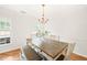 Light-filled dining room features modern chandelier, table, and bench seating at 3401 Sitzman Ct, Raleigh, NC 27616
