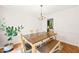 Inviting dining room with wooden table, bench seating, and decorative chandelier at 3401 Sitzman Ct, Raleigh, NC 27616
