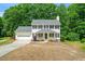 Charming two-story home with a well-maintained lawn, attached garage, and inviting front porch at 3401 Sitzman Ct, Raleigh, NC 27616