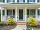 Inviting front porch with white railings and decorative plants at 3401 Sitzman Ct, Raleigh, NC 27616