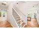Hallway features staircase with iron railing and view into the living area at 3401 Sitzman Ct, Raleigh, NC 27616