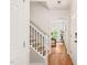 Hallway with wood floors, staircase, and natural light from the front door at 3401 Sitzman Ct, Raleigh, NC 27616