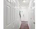 Bright hallway features hardwood floors and ample storage with white closet doors at 3401 Sitzman Ct, Raleigh, NC 27616