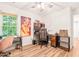 Home office featuring multiple work areas, ceiling fan and large windows providing natural light at 3401 Sitzman Ct, Raleigh, NC 27616
