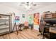 Home office featuring multiple work areas, ceiling fan and large windows providing natural light at 3401 Sitzman Ct, Raleigh, NC 27616