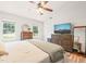 Bright main bedroom with neutral walls, ceiling fan, and wood grain dresser at 3401 Sitzman Ct, Raleigh, NC 27616