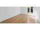 Bright bedroom featuring hardwood floors, a window with natural light, and white walls at 3504 Lexham Ct, Apex, NC 27539