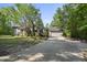 View of the side of the home with a detached garage and long driveway at 3504 Lexham Ct, Apex, NC 27539
