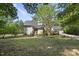 Charming home with a red door, mature trees, and a well-maintained lawn at 3504 Lexham Ct, Apex, NC 27539
