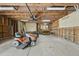 Spacious garage with pegboard, shelving, work table, and riding lawn mower offers ample storage and workspace at 3504 Lexham Ct, Apex, NC 27539