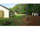 Expansive backyard with lush lawn, firepit, and playset at 3709 Fan Palm Ct, Raleigh, NC 27616