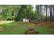 Large backyard with a lush lawn, playset, shed, and firepit at 3709 Fan Palm Ct, Raleigh, NC 27616