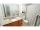 Bathroom featuring a granite countertop vanity, framed mirror, and a shower-tub combo with curtain at 3709 Fan Palm Ct, Raleigh, NC 27616
