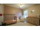 Neutral toned Bedroom featuring a crib, a dresser and a comfortable seating chair at 3709 Fan Palm Ct, Raleigh, NC 27616