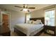 Comfortable bedroom with a ceiling fan, and large windows for ample natural lighting at 3709 Fan Palm Ct, Raleigh, NC 27616