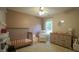 Neutral toned Bedroom featuring a crib, a dresser and a comfortable seating chair at 3709 Fan Palm Ct, Raleigh, NC 27616