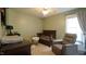 Well-lit Bedroom featuring a crib, comfortable seating chair, and modern baby changing table at 3709 Fan Palm Ct, Raleigh, NC 27616