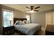 Comfortable bedroom featuring a ceiling fan, and large windows for ample natural lighting at 3709 Fan Palm Ct, Raleigh, NC 27616