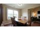 Traditional dining room with hardwood floors and light fixture and a large window at 3709 Fan Palm Ct, Raleigh, NC 27616