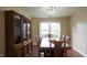 Elegant dining room showcases a china cabinet, seating for six and natural light from the window at 3709 Fan Palm Ct, Raleigh, NC 27616