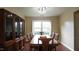 Bright dining room features seating for eight, china cabinet and large window at 3709 Fan Palm Ct, Raleigh, NC 27616