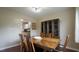 Well-lit dining room features seating for four and access to the kitchen at 3709 Fan Palm Ct, Raleigh, NC 27616