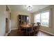 Spacious dining room boasts a large window, hardwood floors and ample seating for six at 3709 Fan Palm Ct, Raleigh, NC 27616